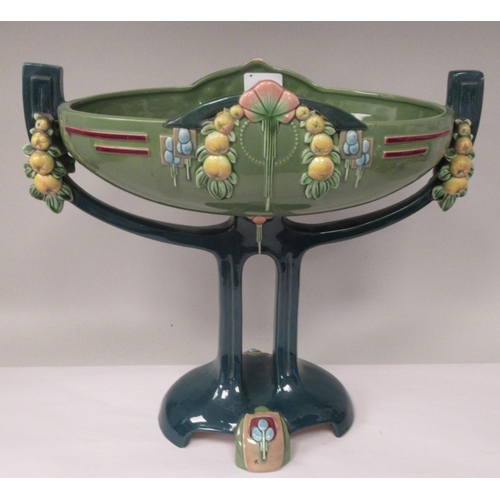 37 - An Art Deco two tone blue/green glazed pottery table centrepiece oval bowl, elevated on a twin pedes... 