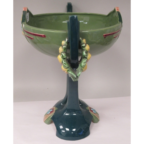 37 - An Art Deco two tone blue/green glazed pottery table centrepiece oval bowl, elevated on a twin pedes... 