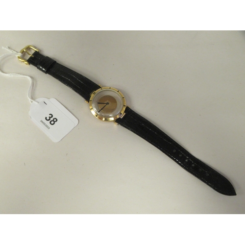 38 - A Jaeger LeCoultre 18ct gold cased Mystery wristwatch, stamped A566948, faced by a baton dial on the... 