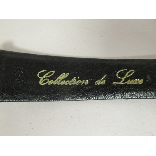 38 - A Jaeger LeCoultre 18ct gold cased Mystery wristwatch, stamped A566948, faced by a baton dial on the... 