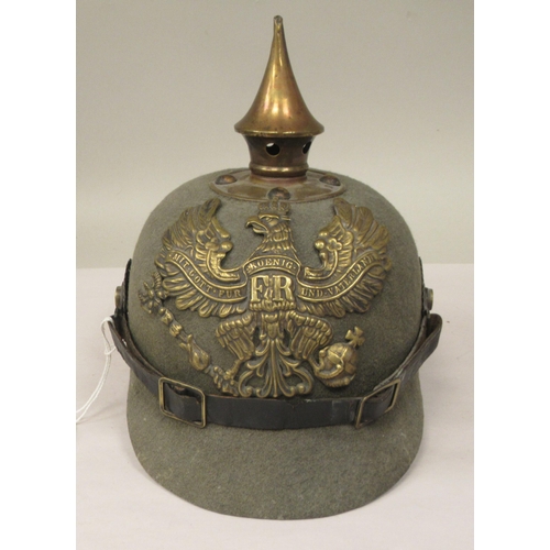 57 - A Great War period German moulded khaki coloured felt pickelhaube with a hide liner and chinstrap(Pl... 