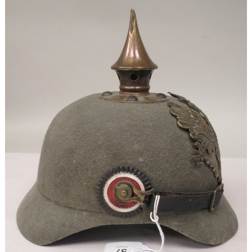 57 - A Great War period German moulded khaki coloured felt pickelhaube with a hide liner and chinstrap(Pl... 
