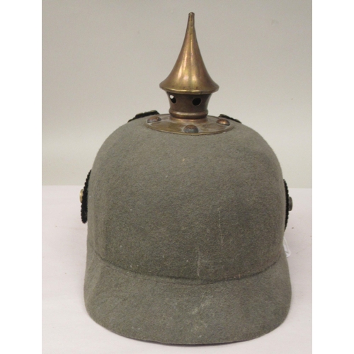 57 - A Great War period German moulded khaki coloured felt pickelhaube with a hide liner and chinstrap(Pl... 