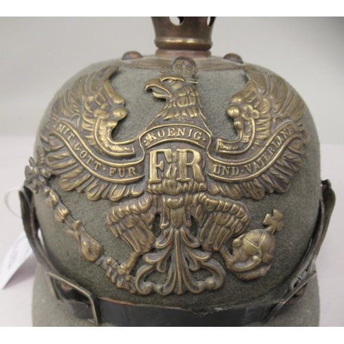 57 - A Great War period German moulded khaki coloured felt pickelhaube with a hide liner and chinstrap(Pl... 