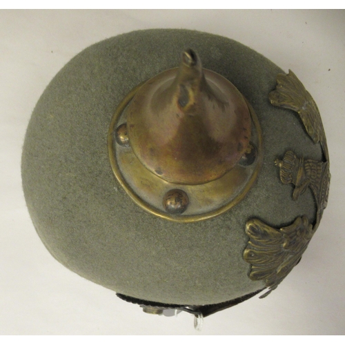 57 - A Great War period German moulded khaki coloured felt pickelhaube with a hide liner and chinstrap(Pl... 