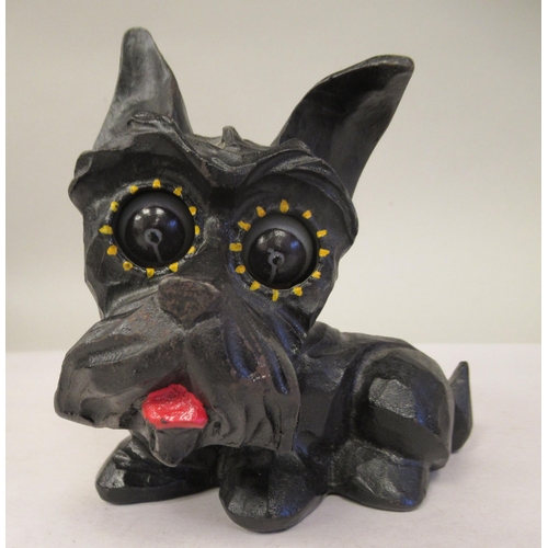 8 - An Art Deco German Oswald Rolling Eye clockwork, novelty timepiece, in a black painted cast iron cas... 