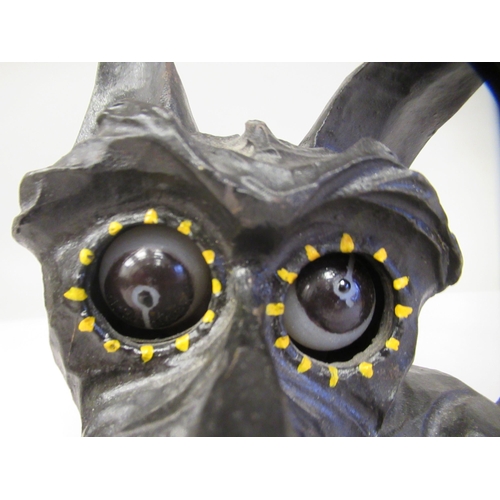 8 - An Art Deco German Oswald Rolling Eye clockwork, novelty timepiece, in a black painted cast iron cas... 