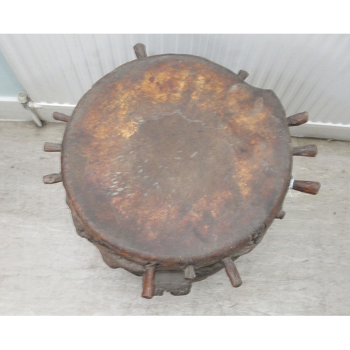 62 - An early 20thC North African tribal drum of barrel design with chip carved ornament and a stretched ... 