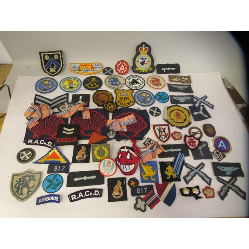 340 - A mixed lot: to include mainly military and other related uniform cloth badges and insignia, some co... 