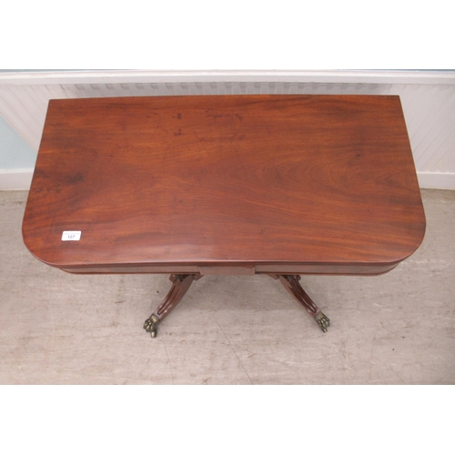 107 - A Regency mahogany tea table with a foldover top, raised on splayed, sabre legs and casters  29