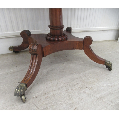 107 - A Regency mahogany tea table with a foldover top, raised on splayed, sabre legs and casters  29