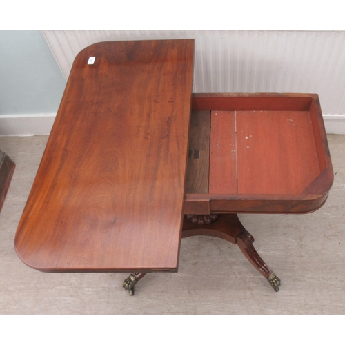 107 - A Regency mahogany tea table with a foldover top, raised on splayed, sabre legs and casters  29