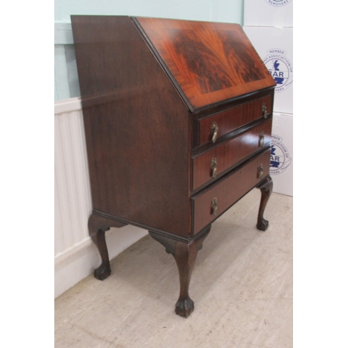 112 - A mid 20thC mahogany finished bureau with a fall front, over three long drawers, raised on cabriole ... 