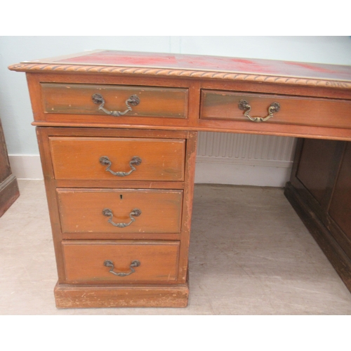 113 - A mid 20thC mahogany nine drawer, twin pedestal desk, on a plinth  30