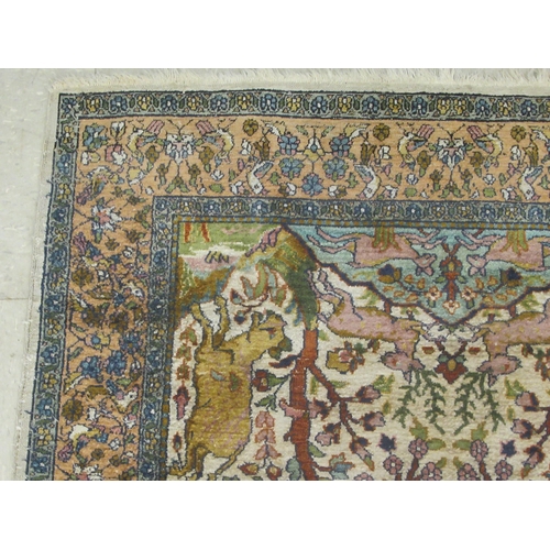 129 - A Persian tree of life design rug, on a beige and blue ground  55