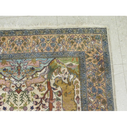 129 - A Persian tree of life design rug, on a beige and blue ground  55