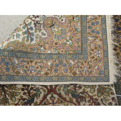 129 - A Persian tree of life design rug, on a beige and blue ground  55