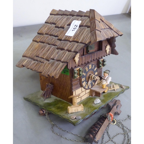 162 - A Black Forest carved cuckoo clock, fashioned as a house  9