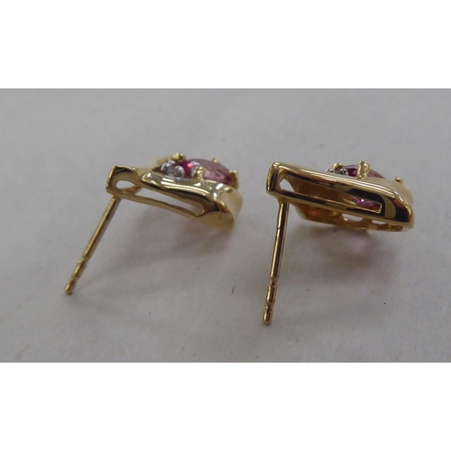 206 - A pair of 10k gold earrings, each set with a pink stone and a diamond