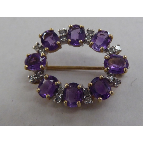 209 - A 9ct gold brooch, set with alternating amethysts and diamonds