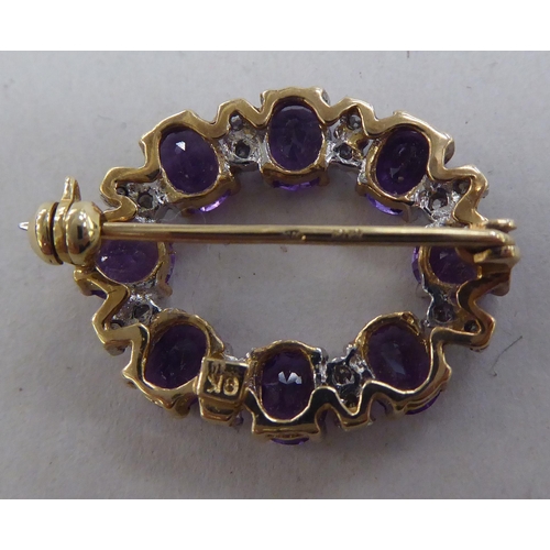 209 - A 9ct gold brooch, set with alternating amethysts and diamonds