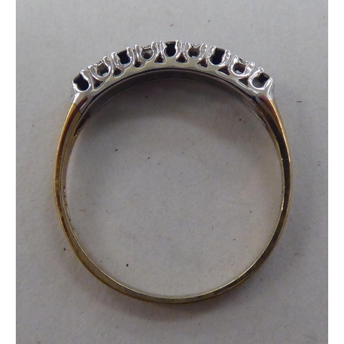 211 - A 9ct gold eternity ring, set with alternating sapphires and diamonds