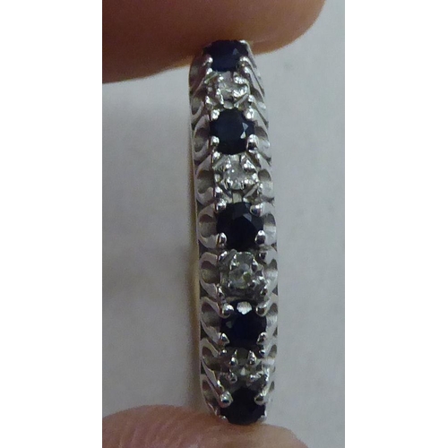 211 - A 9ct gold eternity ring, set with alternating sapphires and diamonds