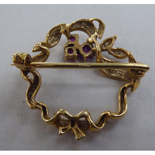 216 - A 9ct gold brooch, set with rubies and diamonds