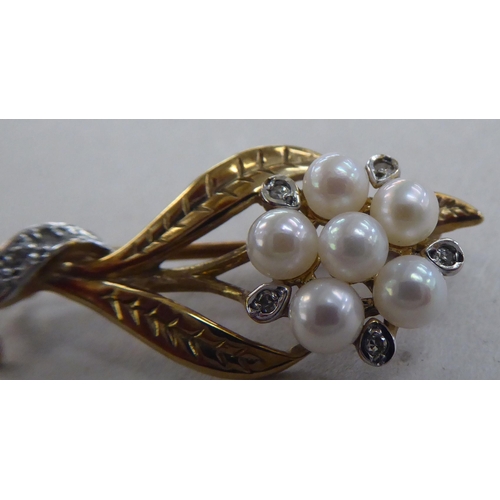 221 - A 9ct gold brooch, fashioned as a bouquet, set with pearls and diamonds