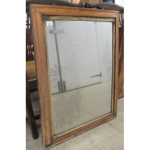 223 - A late 19thC mirror, the plate set in a moulded, simulated maple frame  28