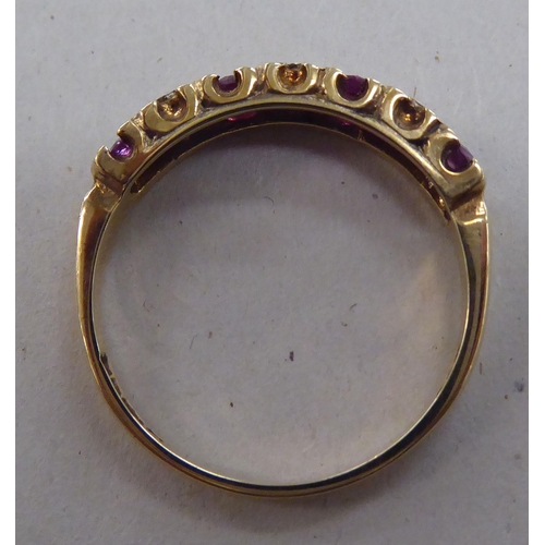 224 - A 9ct gold eternity ring, set with alternating rubies and diamonds