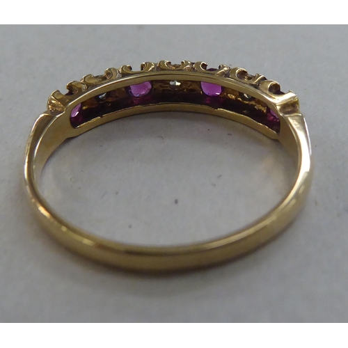 224 - A 9ct gold eternity ring, set with alternating rubies and diamonds