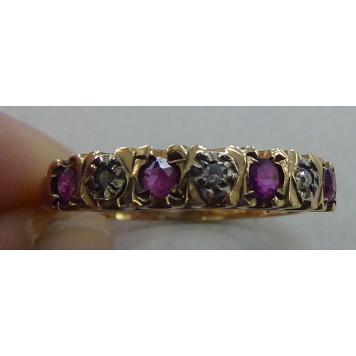 224 - A 9ct gold eternity ring, set with alternating rubies and diamonds