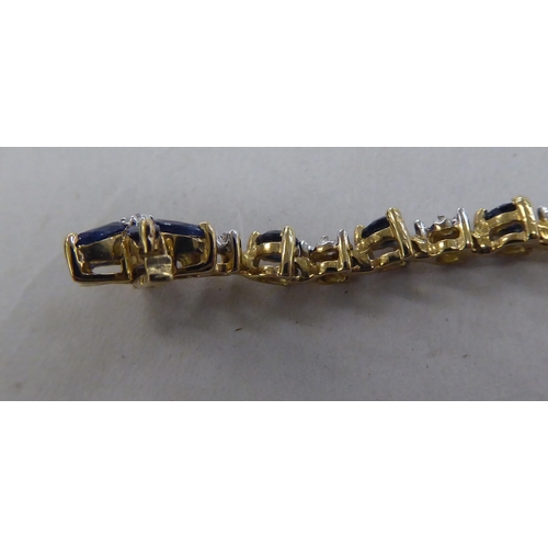 226 - A 10k gold bracelet, set with sapphires and diamonds