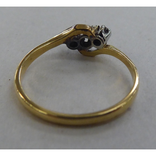 229 - An 18ct gold ring, set with three diamonds