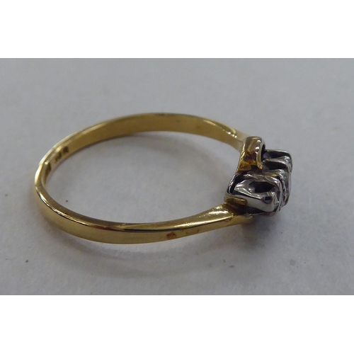 229 - An 18ct gold ring, set with three diamonds