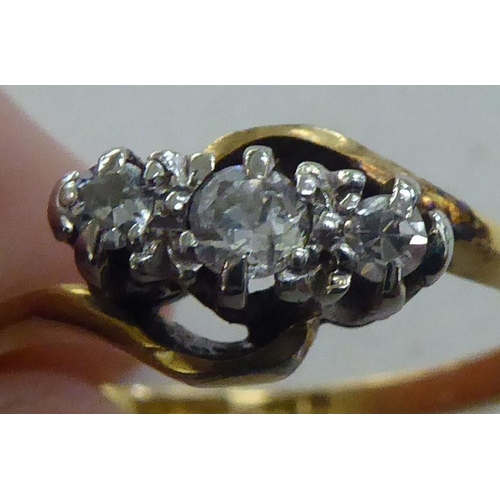 229 - An 18ct gold ring, set with three diamonds