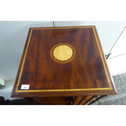 23 - An Edwardian satinwood inlaid mahogany and marquetry three tier revolving bookcase with slatted side... 