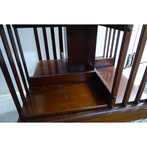 23 - An Edwardian satinwood inlaid mahogany and marquetry three tier revolving bookcase with slatted side... 