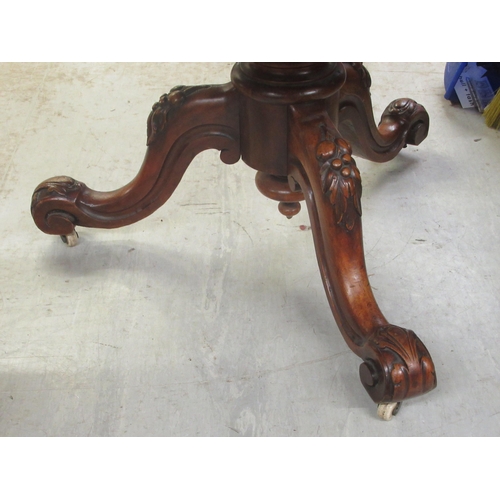 251 - A late Victorian mahogany pedestal centre table with a thumb moulded edge, raised on a carved tripod... 