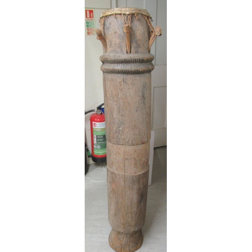 261 - An African carved hardwood, floorstanding tribal drum  54