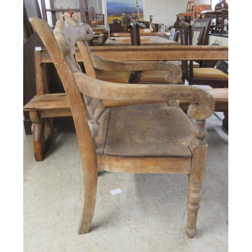 280 - A 19thC rustically constructed oak and pine, open arm, splat back veranda chair, the solid seat rais... 