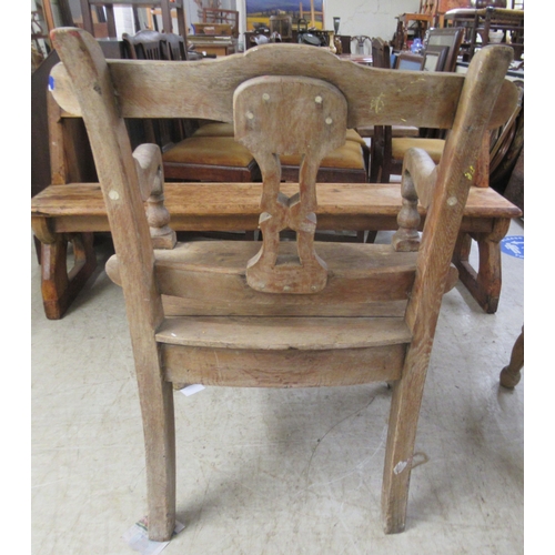 280 - A 19thC rustically constructed oak and pine, open arm, splat back veranda chair, the solid seat rais... 