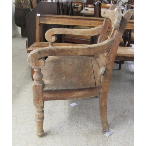 280 - A 19thC rustically constructed oak and pine, open arm, splat back veranda chair, the solid seat rais... 