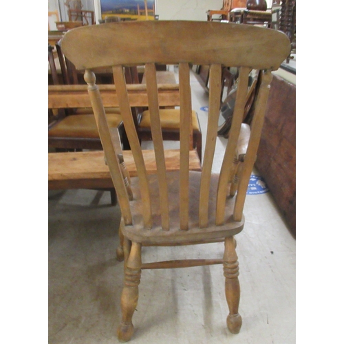 283 - A 19thC Windsor beech and elm framed, lath back, open arm chair, the solid seat raised on turned leg... 