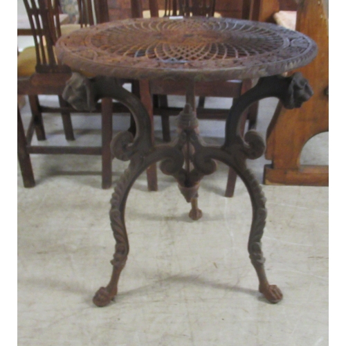 285 - A Continental inspired, cast iron patio table, decorated with fruiting vine and pierced crossover to... 