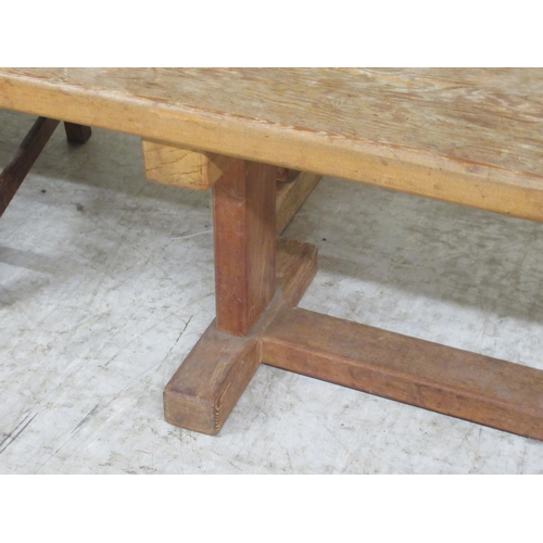 286 - An early 20thC rustically constructed, bleached oak, planked refectory table, raised on block suppor... 