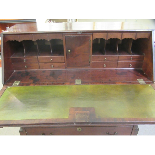 3 - A George III mahogany bureau with a fall front, enclosing a fitted interior, over two short/three gr... 