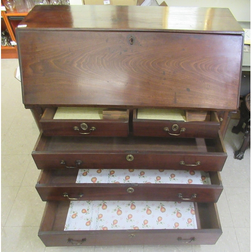 3 - A George III mahogany bureau with a fall front, enclosing a fitted interior, over two short/three gr... 