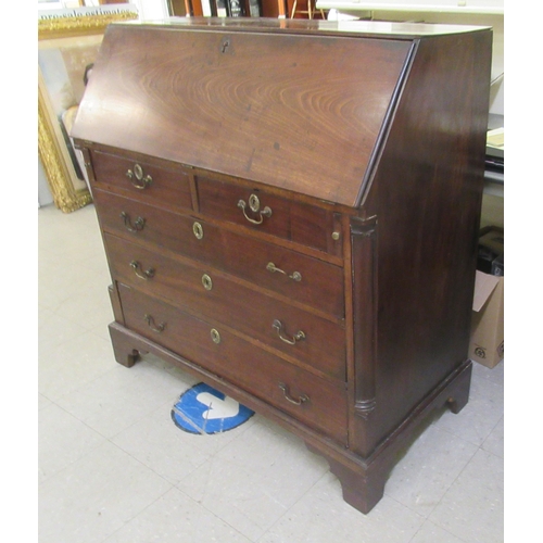 3 - A George III mahogany bureau with a fall front, enclosing a fitted interior, over two short/three gr... 